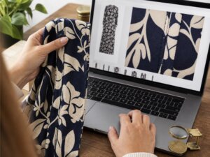 Shopper compares aligned garment seams with enlarged product photos on a laptop
